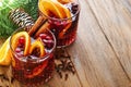 Christmas hot mulled wine. Glasses of mulled wine with aromatic spices cinnamon, anise, sugar and fir tree branches with bokeh and Royalty Free Stock Photo