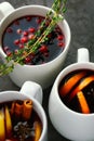 Christmas hot mulled wine or gluhwein drink in a cups with orange citrus,apple,cinnamon sticks and stars anise Royalty Free Stock Photo