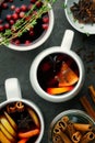 Christmas hot mulled wine or gluhwein drink in a cups with orange citrus,apple,cinnamon sticks and stars anise Royalty Free Stock Photo
