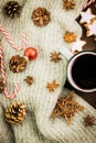 Christmas hot steaming cup of glint wine with spices, anise, cookies in a shape of star, red candies, pepper, fir cones and gray