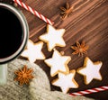 Christmas hot steaming cup of glint wine with spices, anise, cookies in a shape of star, red candies, pepper and gray scarf on