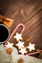 Christmas hot steaming cup of glint wine with spices, cinnamon, anise, cookies in a shape of star, red candies, pepper and gray