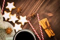 Christmas hot steaming cup of glint wine with spices, cinnamon, anise, cookies in a shape of star, red candies, pepper and gray