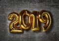 2019 Christmas inflatable gold numbers balloons on the loft wall background new year