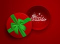 Christmas inscription in the open red gift box with green ribbon and bow isolated on red background. Top view. Template Royalty Free Stock Photo