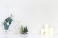 Christmas interior, candles, decorative Christmas trees, Christmas wreath in the shape of a star decorated with eucalyptus branch Royalty Free Stock Photo