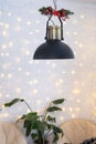 Christmas interior of a loft-style house with a black decorated retro lampshade and indoor plants of Strelitzia nicolai. New Year