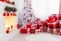 Christmas interior in red and white colors with tree and fireplace Royalty Free Stock Photo