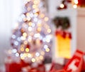 Christmas interior in red and white colors with tree and fireplace Royalty Free Stock Photo