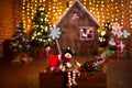 Christmas interior with wooden house, candy, tree and gifts. No people. Holiday background Royalty Free Stock Photo