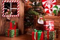 Christmas interior with wooden house, candy, tree and gifts. No people. Holiday background Royalty Free Stock Photo