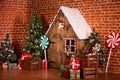 Christmas interior with wooden house, candy, tree and gifts. No people. Holiday background Royalty Free Stock Photo