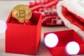 Christmas investing,bitcoin in a gift box on the background of a christmas tree and lights Royalty Free Stock Photo