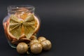 Christmas jar of dry sliced oranges and golden balls