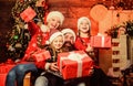 Christmas joy. Happy holidays. Parents and children opening christmas gifts. Father Santa claus and mother little