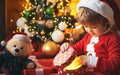 Christmas kid. Happy little smiling boy with christmas gift box. Happy child holding a red gift box with both hands Royalty Free Stock Photo