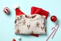 Christmas kids clothes set. Cotton pants, sweater, Christmas hat and decorations on blue background Royalty Free Stock Photo