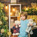 Christmas kids - happiness concept. Home Christmas atmosphere for child. Happy little child dressed in winter clothing Royalty Free Stock Photo