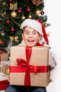 Baby next to the Christmas tree. Christmas Kids. Happy Children Opening Gifts. new year. Boy receiving Christmas gifts Royalty Free Stock Photo