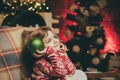 Christmas kids mood. Cute angel of Christmas with shining balls. The child looks up dreamily. Waiting for Christmas Royalty Free Stock Photo