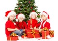 Christmas helpers kids in Santa hat with presents Royalty Free Stock Photo