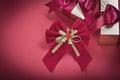 Christmas knot wrapped giftboxes on red background holidays conc Royalty Free Stock Photo