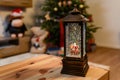 a Christmas lamp stands on a table against the background of a decorated Christmas apartment Royalty Free Stock Photo