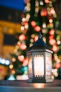 Christmas Lantern With Burning Candle On Bright Blurred Christmas Royalty Free Stock Photo