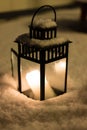 Christmas Lantern with burning candle on Snow Evening Scene Royalty Free Stock Photo