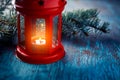 Christmas lantern with a candle and a branch of a Christmas tree