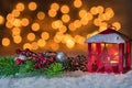 Christmas lantern candle with decoration over snow and sparkling lights background Royalty Free Stock Photo