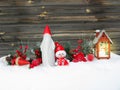 Christmas lantern decoration winter berries and snow on wooden b Royalty Free Stock Photo