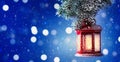 Christmas lantern hanging on snow covered fir branches. Winter cozy scene. Banner format Royalty Free Stock Photo