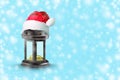 Christmas lantern in the hat of Santa Claus on a blue background. Copy space. New Year. Christmas background. Royalty Free Stock Photo