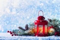 Christmas lantern in snow with fir tree branch. Winter cozy scene Royalty Free Stock Photo