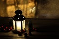 Christmas lantern with snowfall, candles, view from the window on the night street