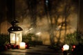 Christmas lantern with snowfall, candles, view from the window on the night street Royalty Free Stock Photo