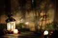 Christmas lantern with snowfall, candles, view from the window on the night street