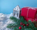 Christmas lantern sweet decoration with snowman next to red gift boxes and spruce branch