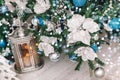 Christmas Lantern under Christmas tree with decoration, snow, blurred, sparking, glowing Royalty Free Stock Photo