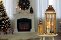 Christmas lanterns with burning candles in decorated living room. Space for text Royalty Free Stock Photo