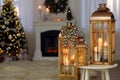 Christmas lanterns with burning candles in decorated living room. Space for text Royalty Free Stock Photo