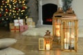 Christmas lanterns with burning candles in decorated living room. Space for text Royalty Free Stock Photo