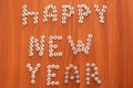 Christmas layout for a carpenter. On a wooden surface, the text Happy New Year is lined with screws