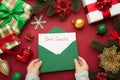 Christmas letter from a child to Santa Claus with the words: Dear Santa. Christmas composition with yellow and green toys Royalty Free Stock Photo