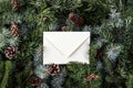 Christmas letter envelope on fir branches background with pine cones. Royalty Free Stock Photo