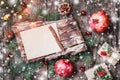 Christmas letter on wooden background with Christmas gifts, bark texture, pomegranate, Fir branches on wooden background