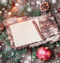 Christmas letter on wooden background with Christmas gifts, bark texture, pomegranate, Fir branches on wooden background.