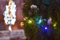 Christmas light background. Decorated with garland trees . Holiday glowing backdrop during the night. Defocused