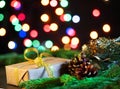 Christmas dark black background, gift and fir branches, magic shining bokeh, empty space for text Royalty Free Stock Photo